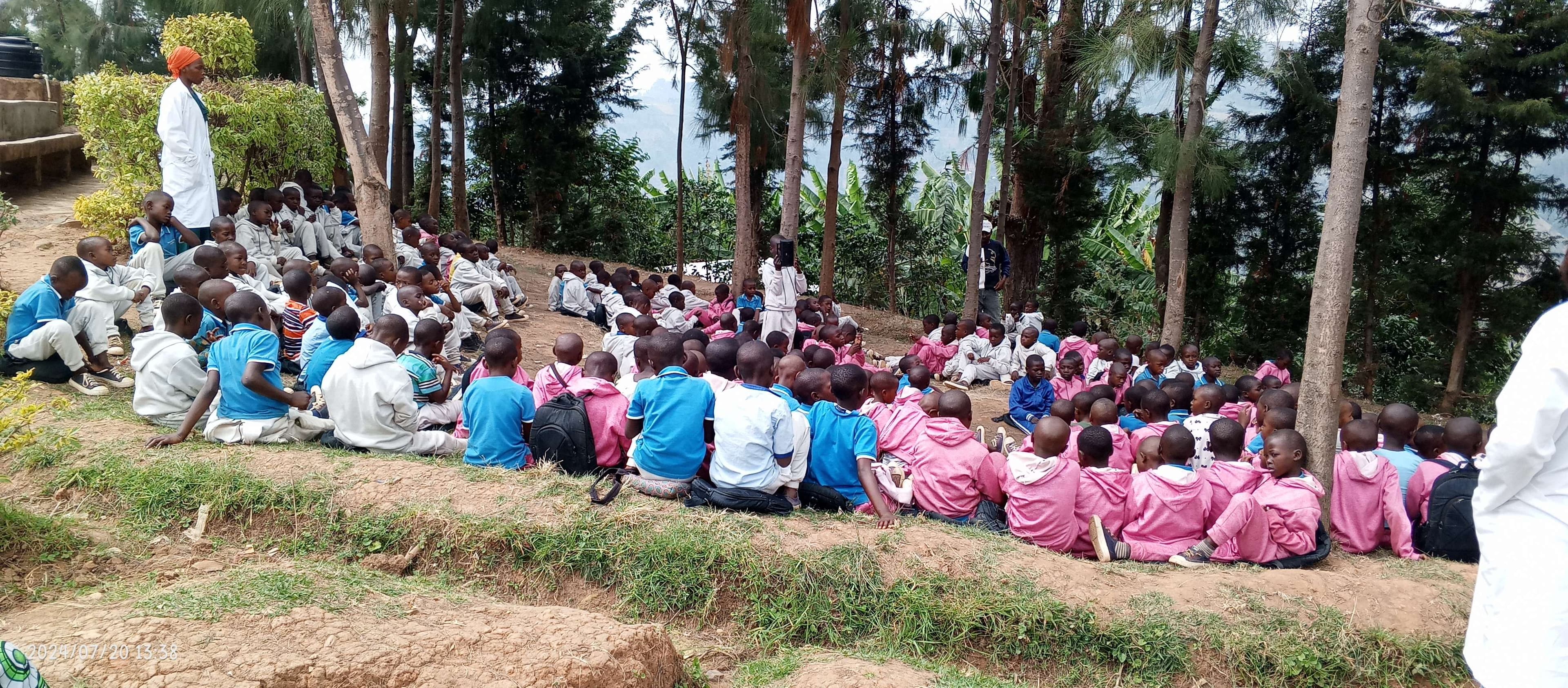 Children listen to drumming lessons outside because they do not hall where this activity can be done.