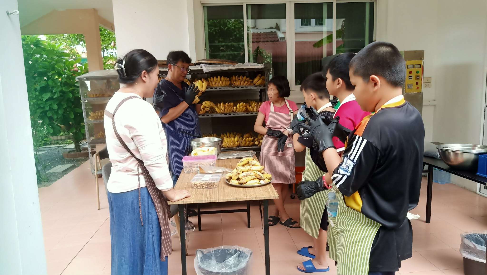 Selecting washed bananas and preparing to peel them.