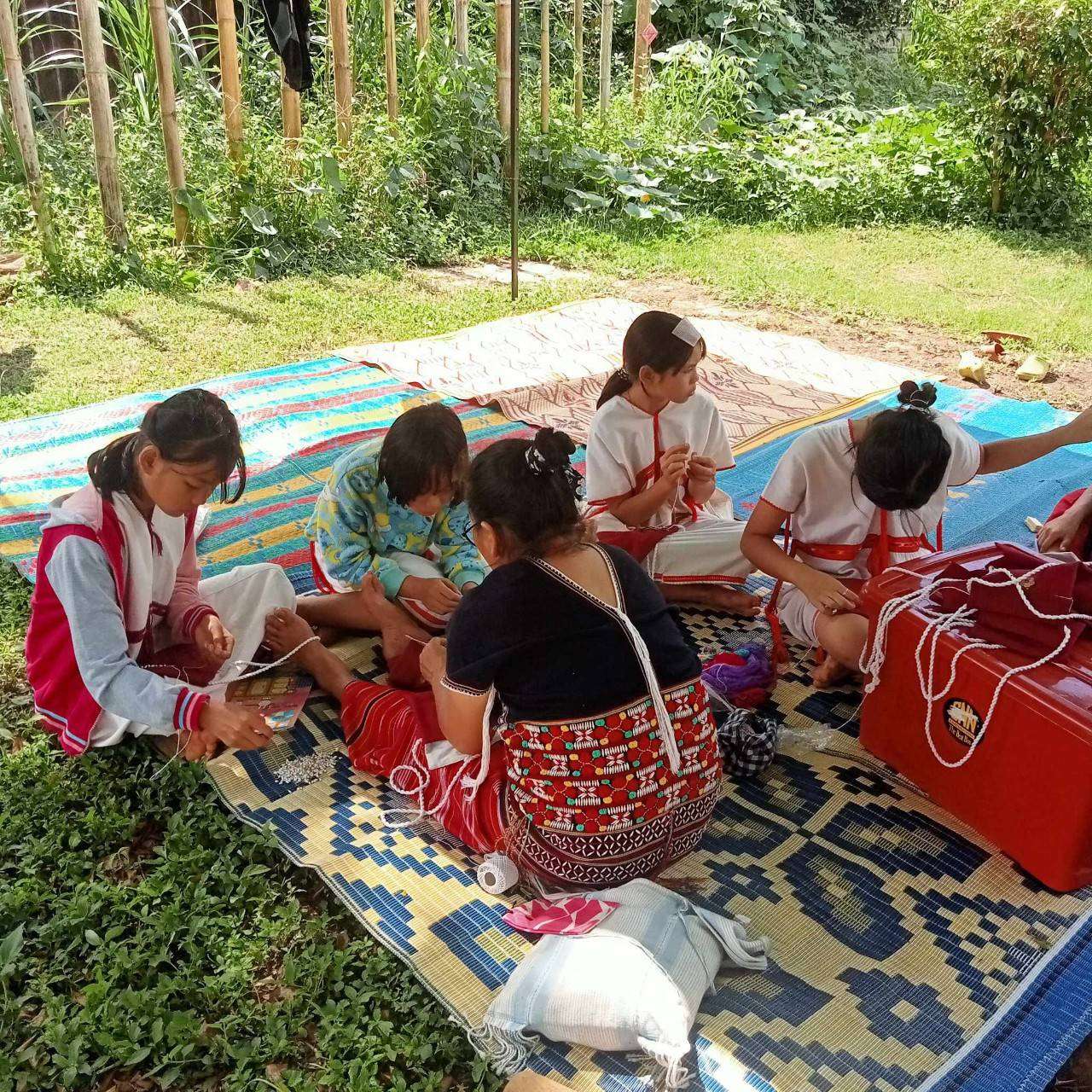 Children learn to embroider traditional patterns.