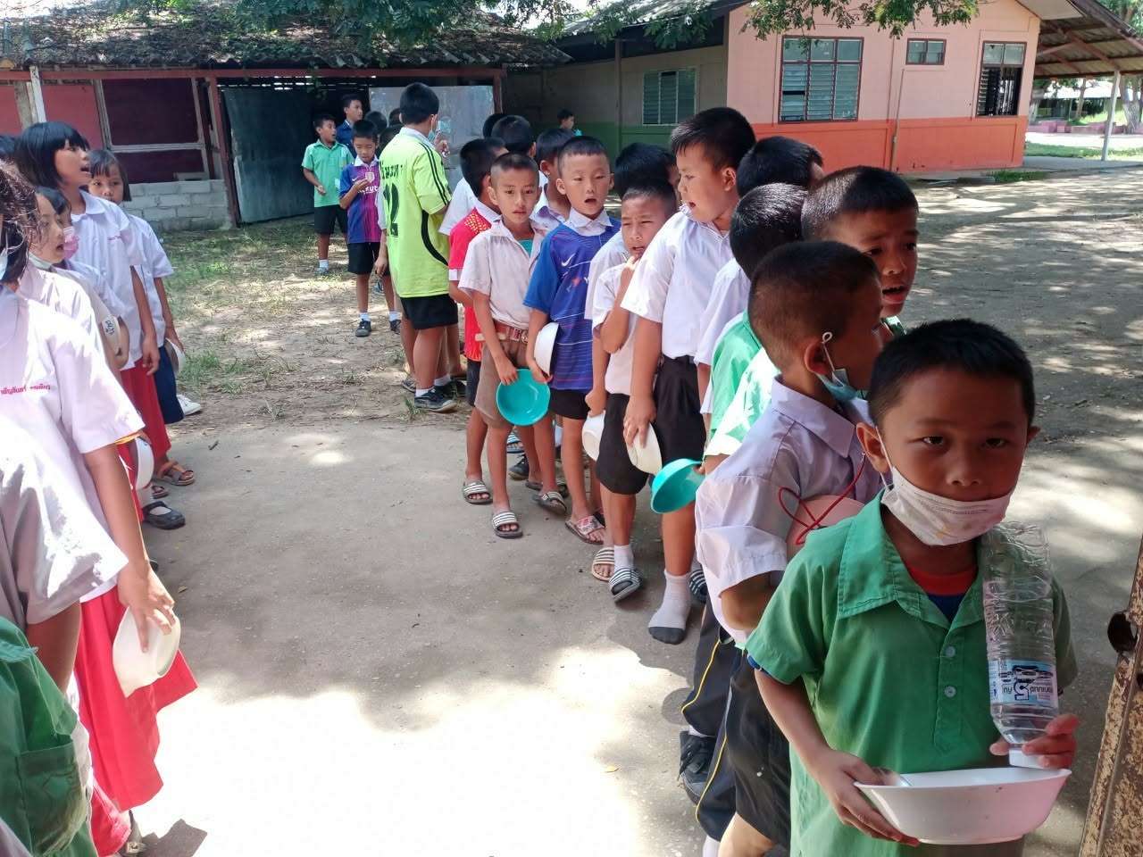 The children are lining up to get their meal