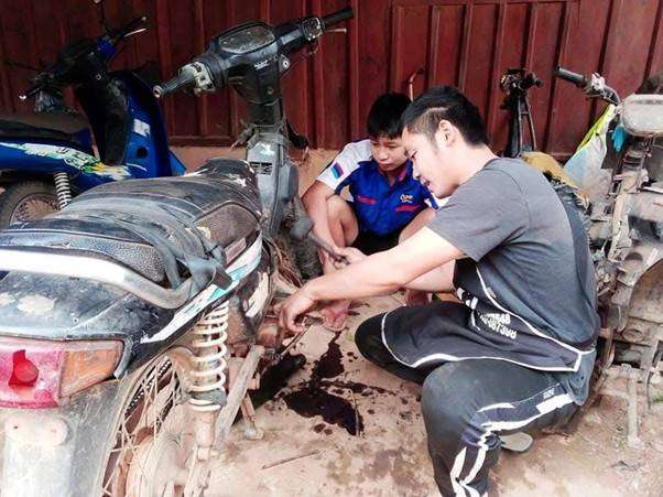 The older students are teaching the younger students how to redeem engine oil.