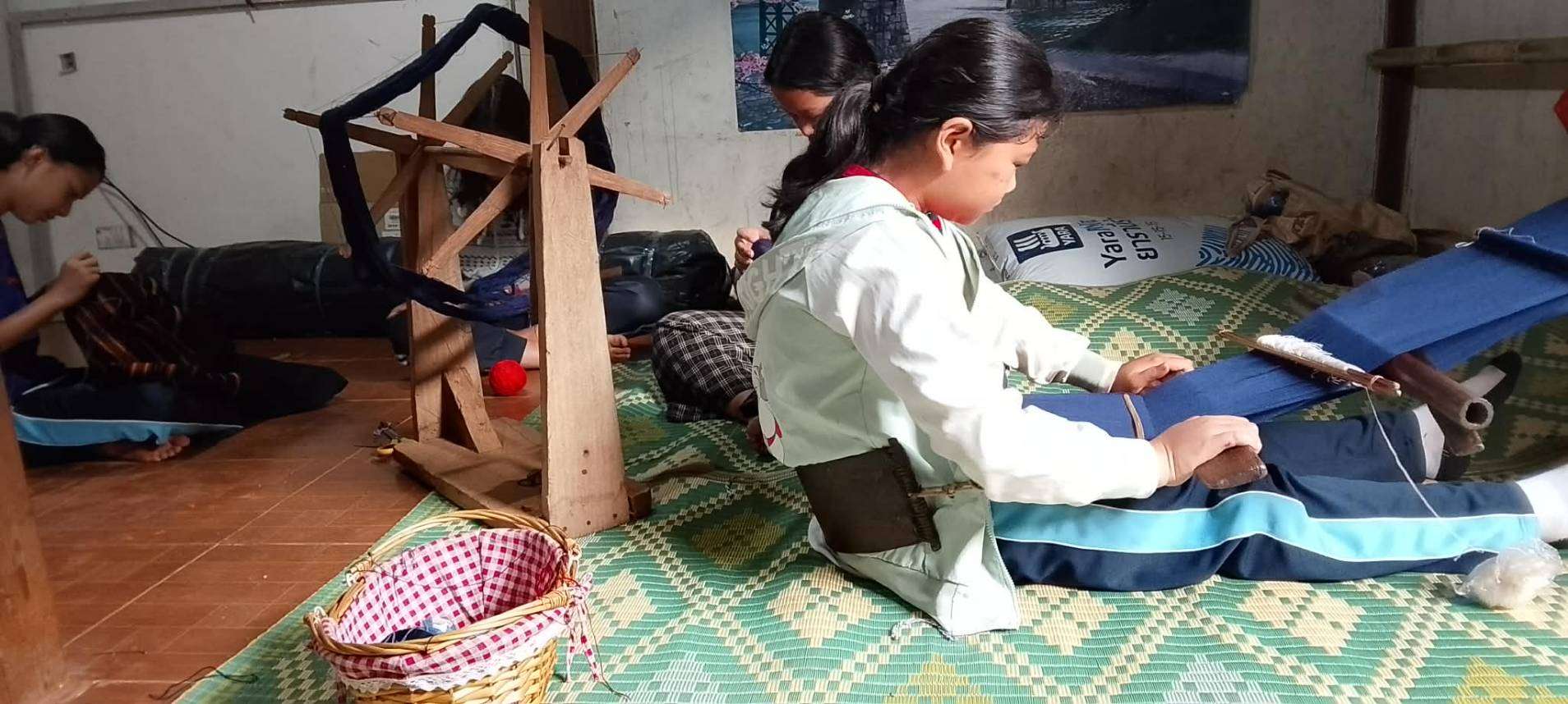 The children are learning how to weave.