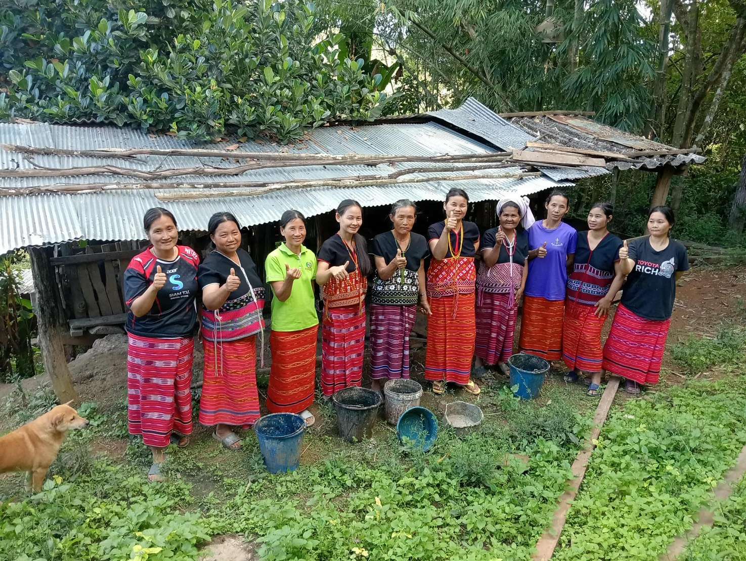 "Community spirit in action: A group photo of women and parents from the church taking turns caring for the pigs!"