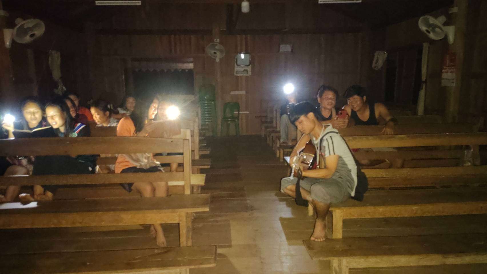 We use my phone as a light while practicing music because the room has no electricity.