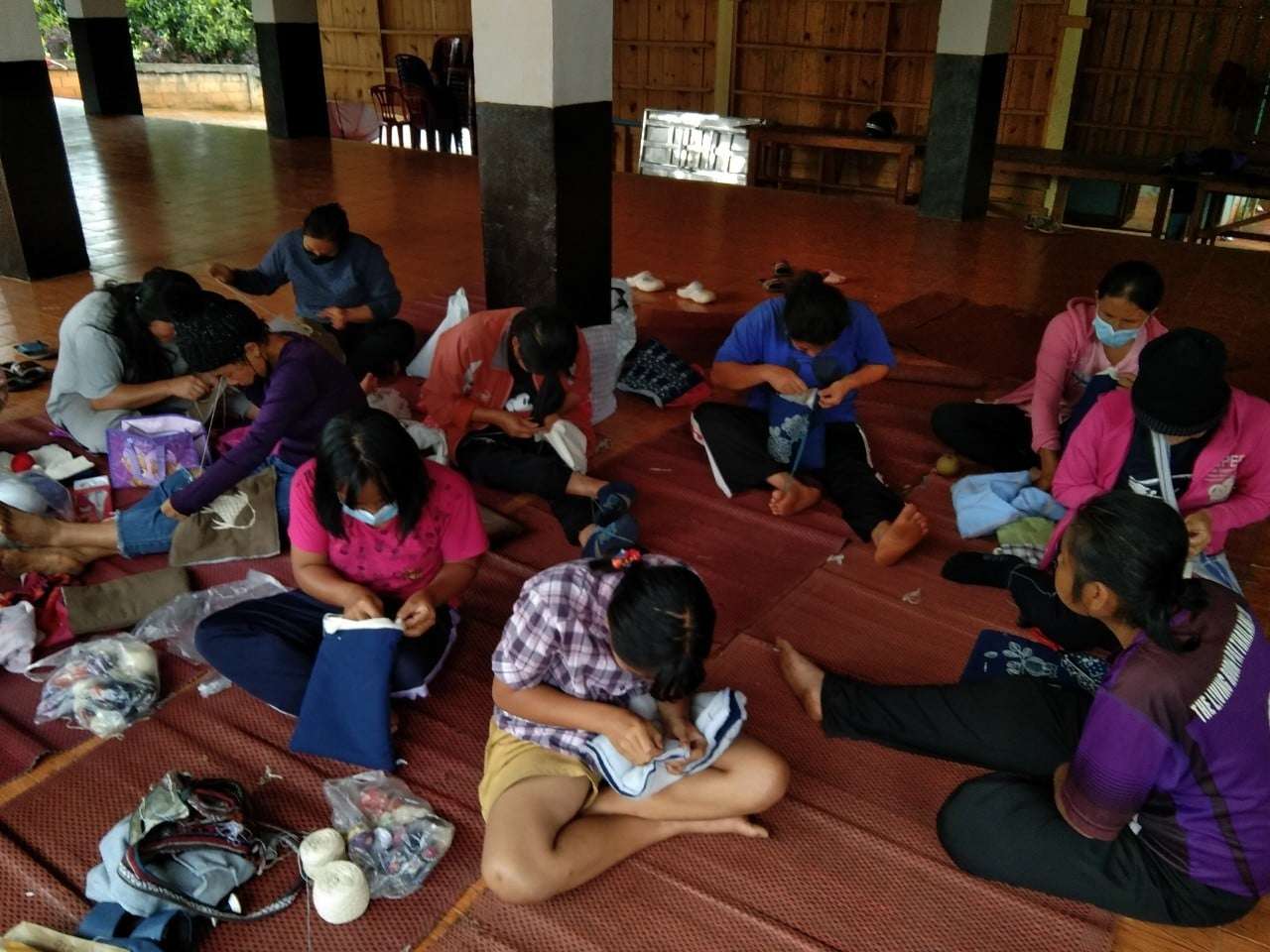 Children participate in learning about design and processing of woven fabrics.