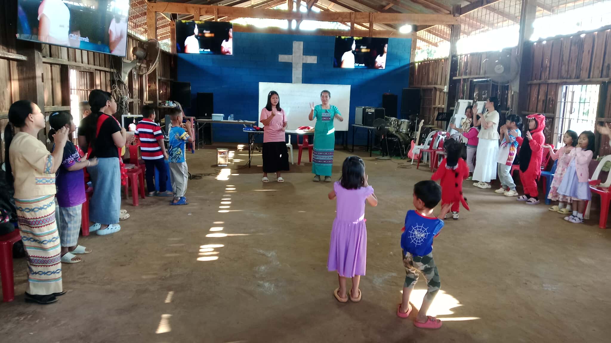 The babysitter is leading the children.