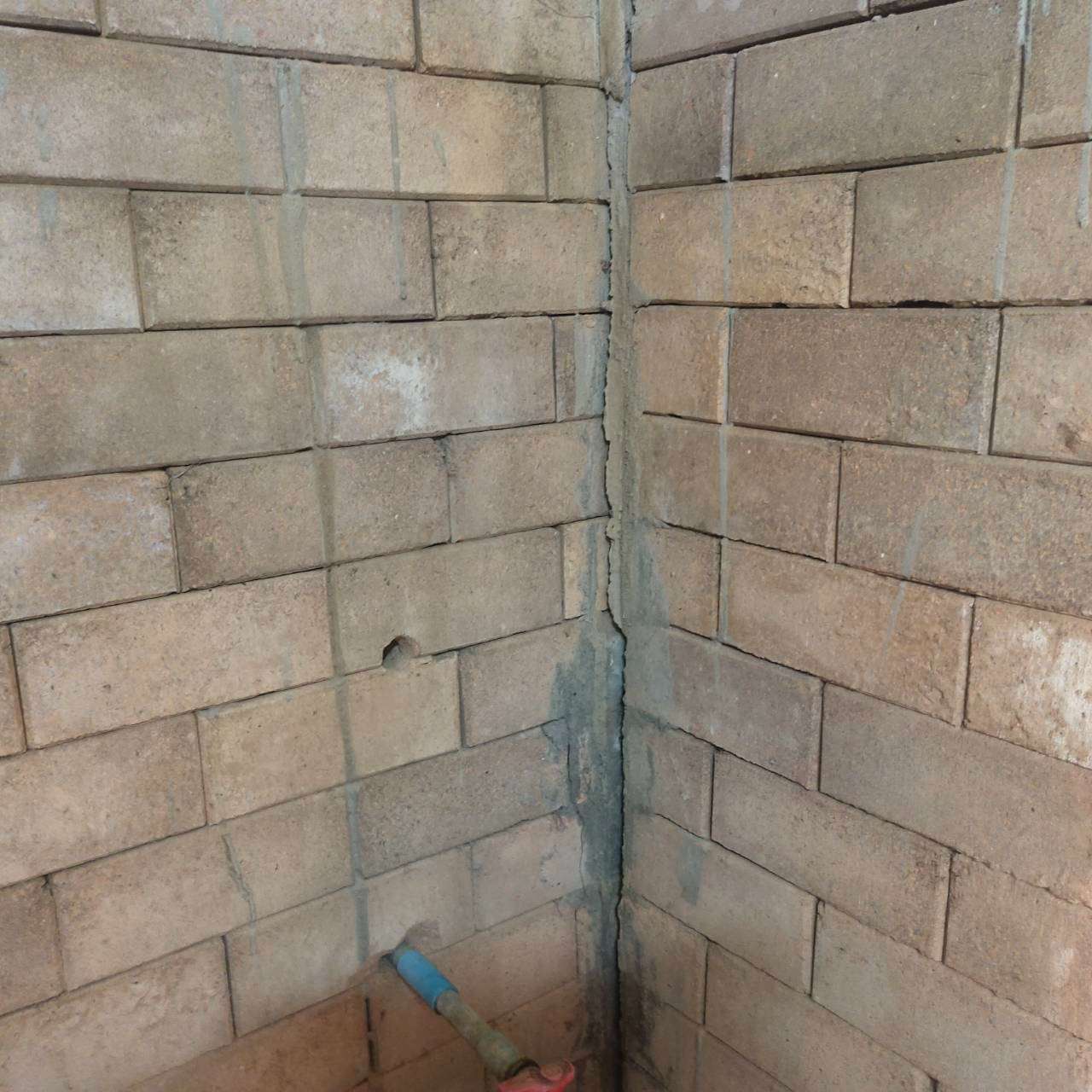The concrete blocks have cracked and become discolored due to prolonged use.