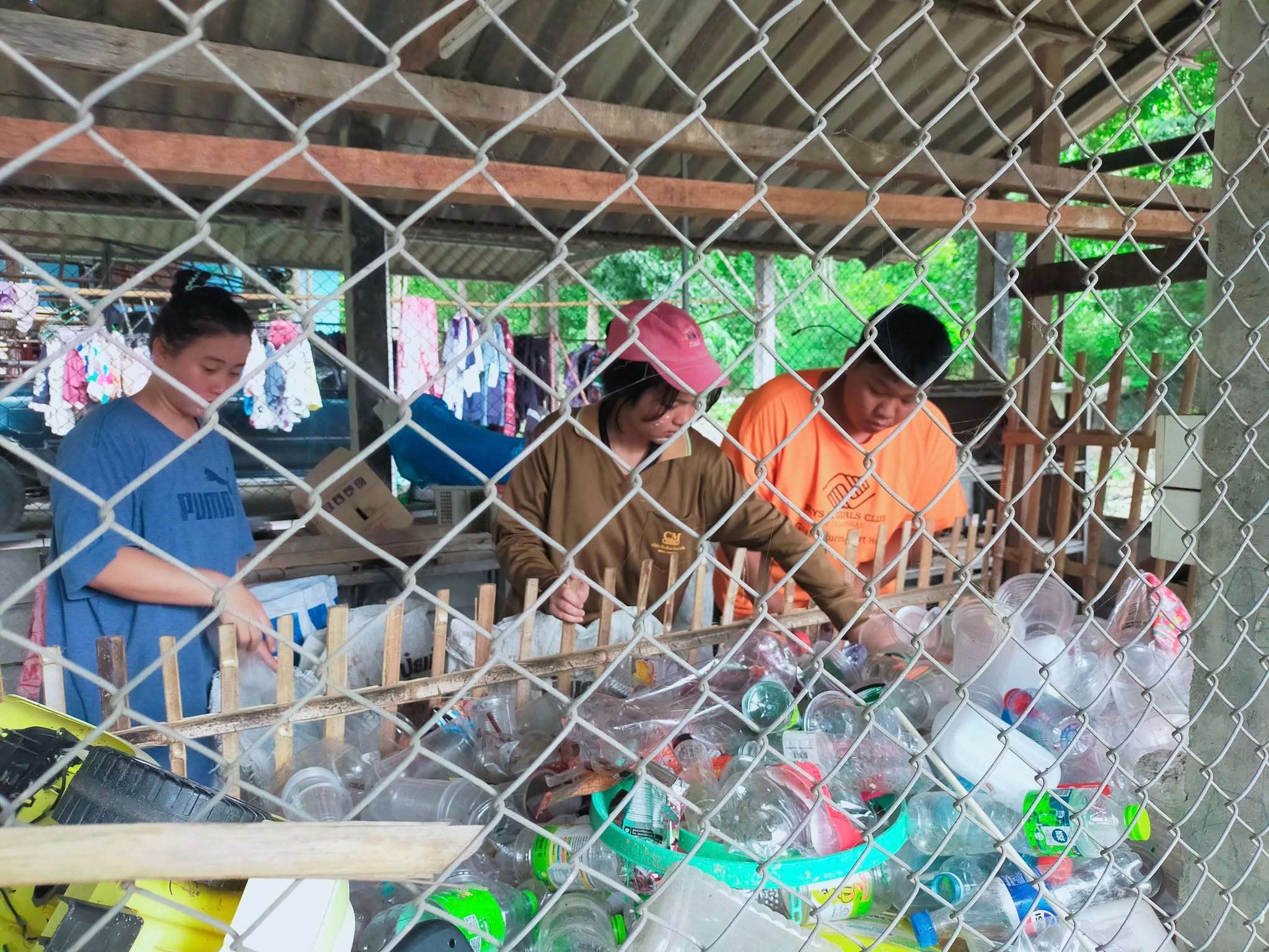 Youth actively sorting waste for a cleaner, greener community.