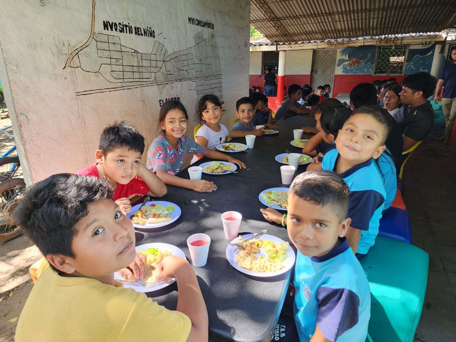 children receiving food in the hallways
