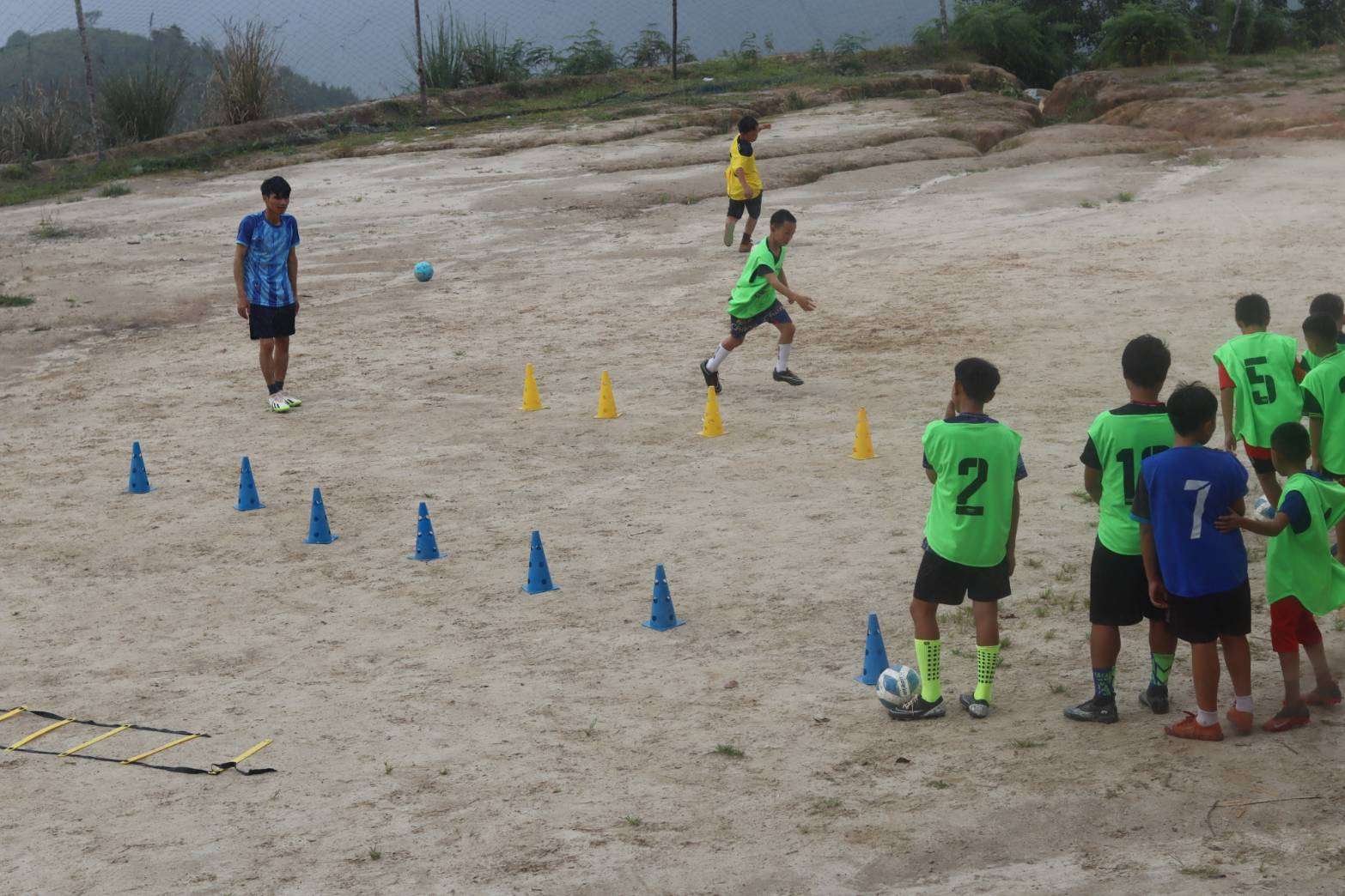 Children engaging in hands-on football training sessions.