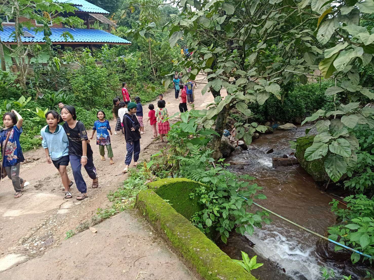 Collecting garbage along the stream in the village