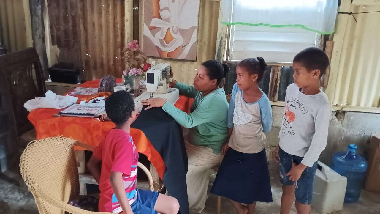 the children and mother doing sewing