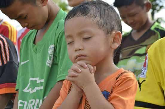 The football field is a place for children to pray and develop their faith.