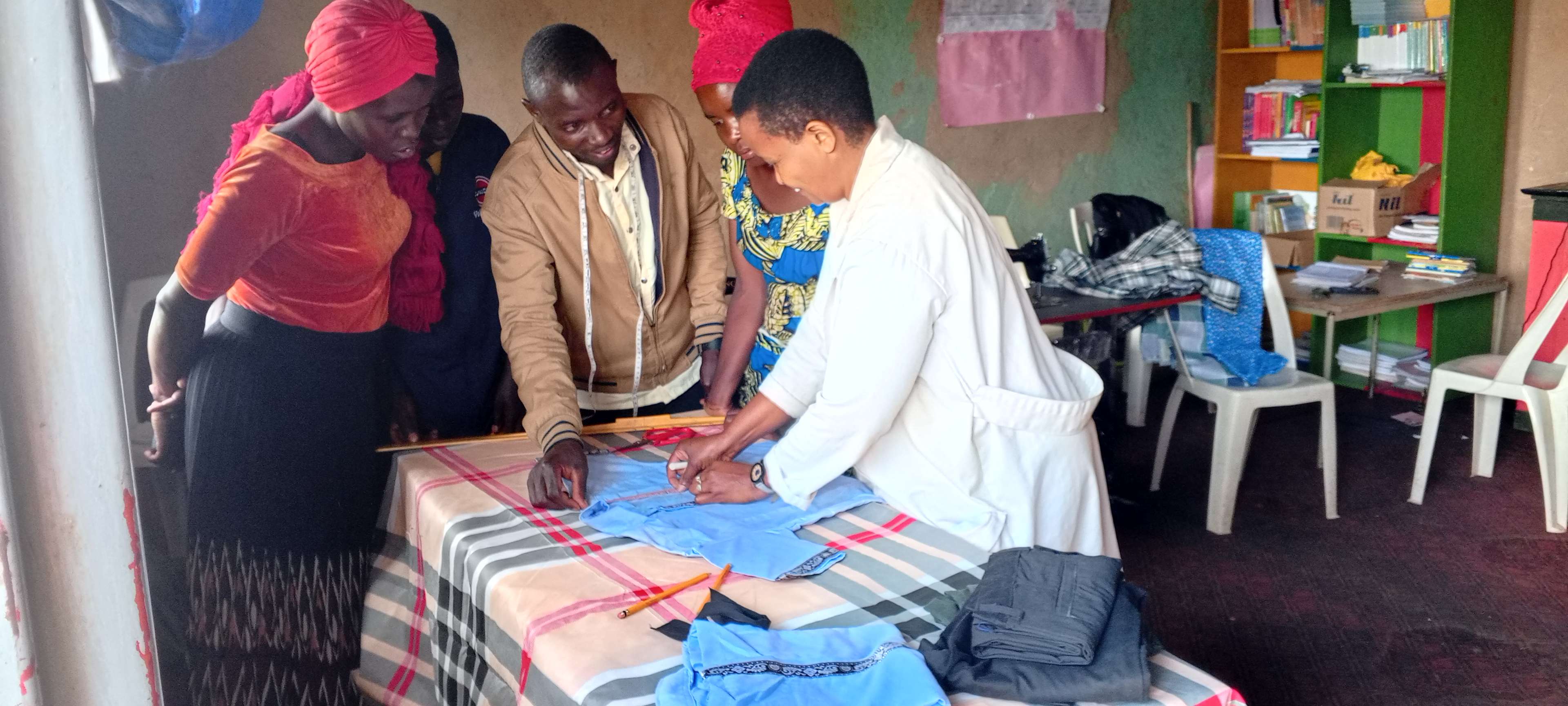 Some caregivers are learning how to take measurements for a shirt.