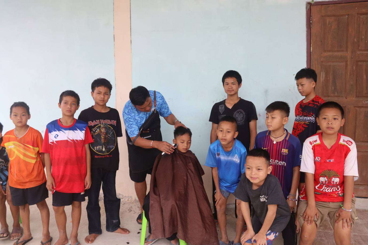 A group of children interested in learning haircutting skills.