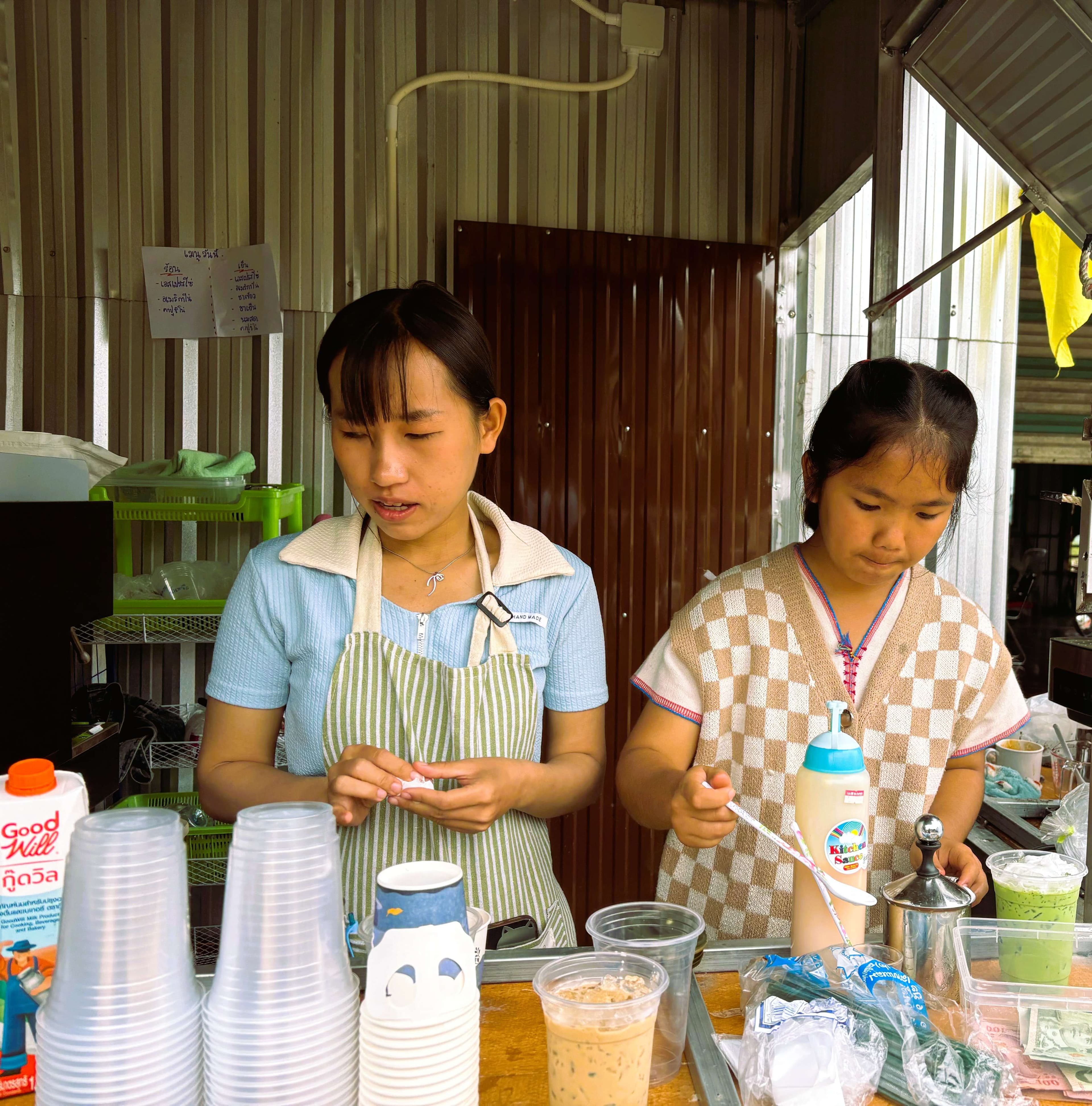 Youth learn and practice coffee brewing.