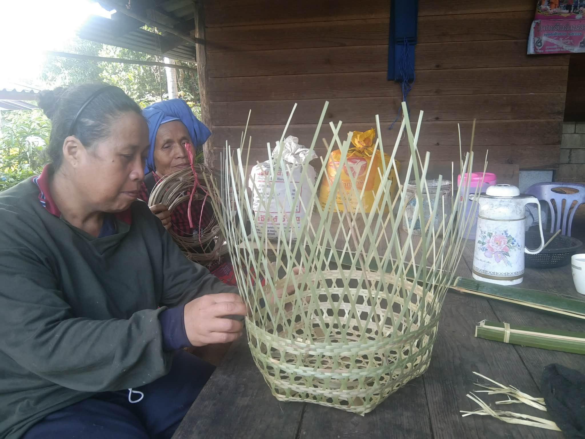 Parents and guardians join their children in learning the art of bamboo weaving, fostering creativity and togetherness