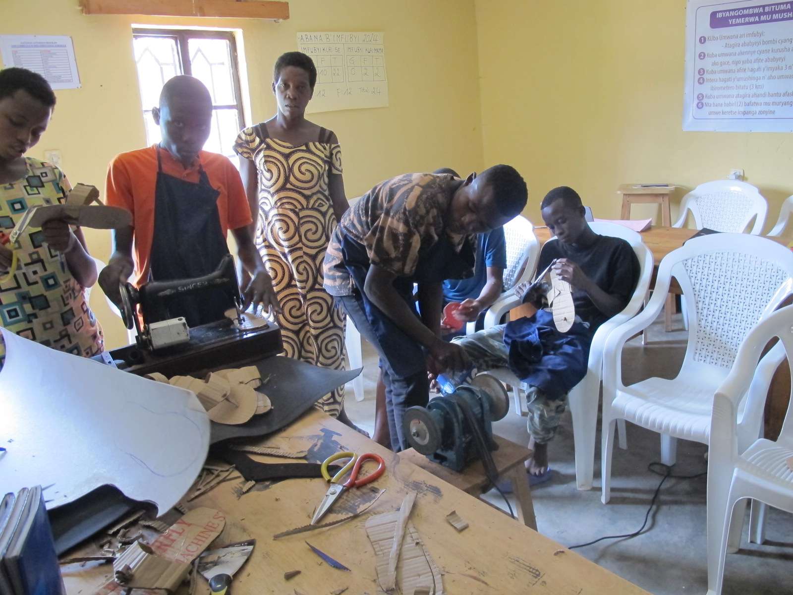 Participants put to use the shoemaking skills they have gained using the sewing machine