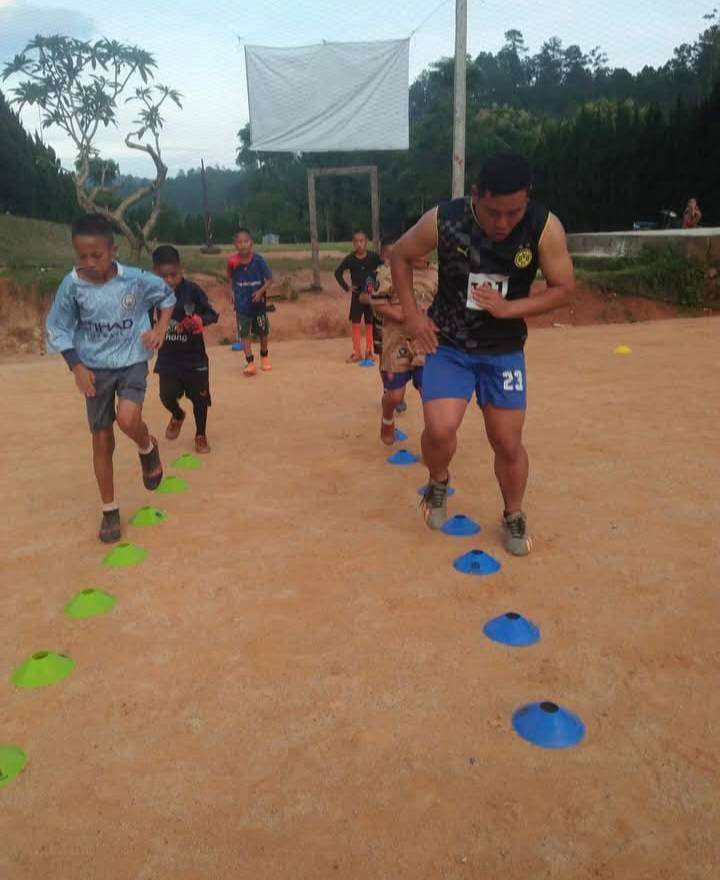 The coach is teaching the kids how to strengthen their thighs.