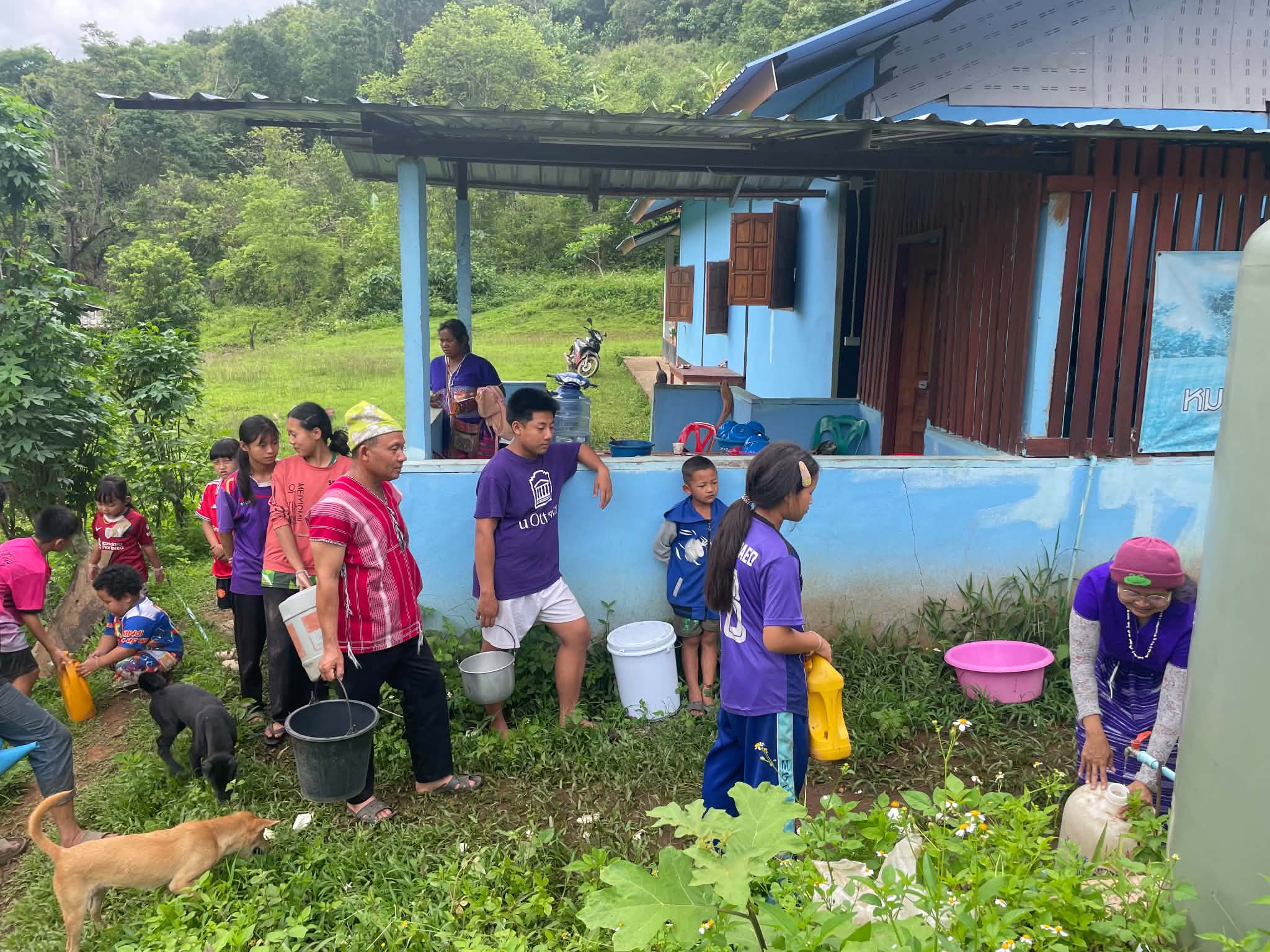 During the dry season, water becomes scarce, and families must wait in line to fetch water from the community tank. 