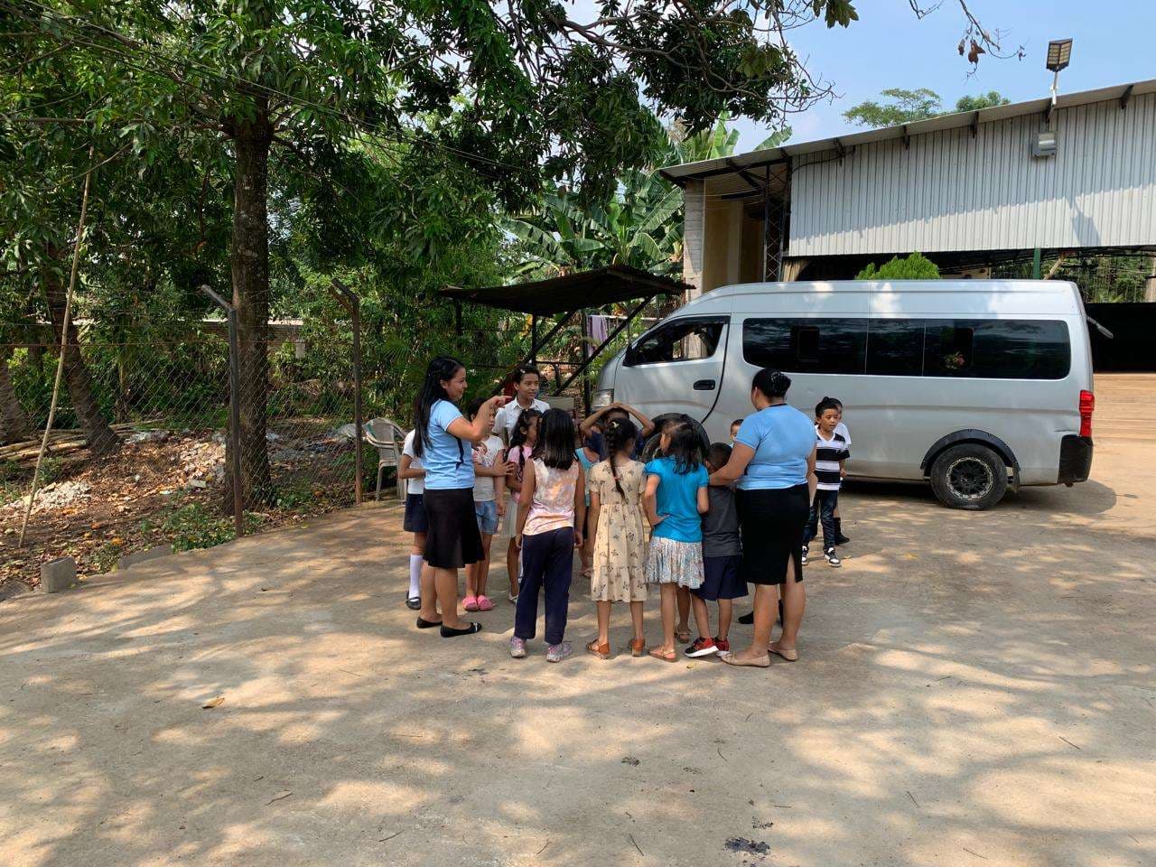 Children and young people doing activities in the parking lot.