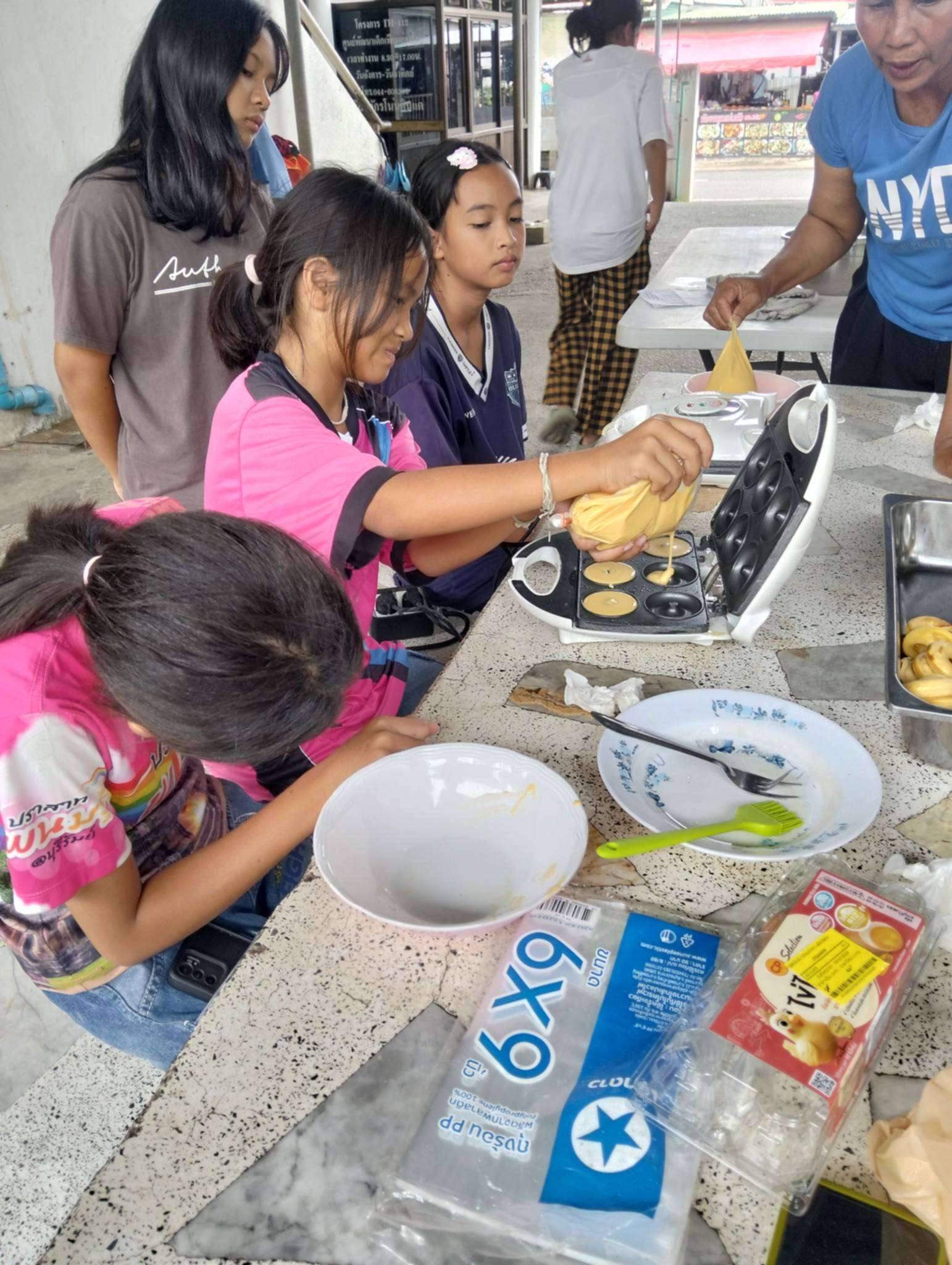 The children are learning how to make donuts.