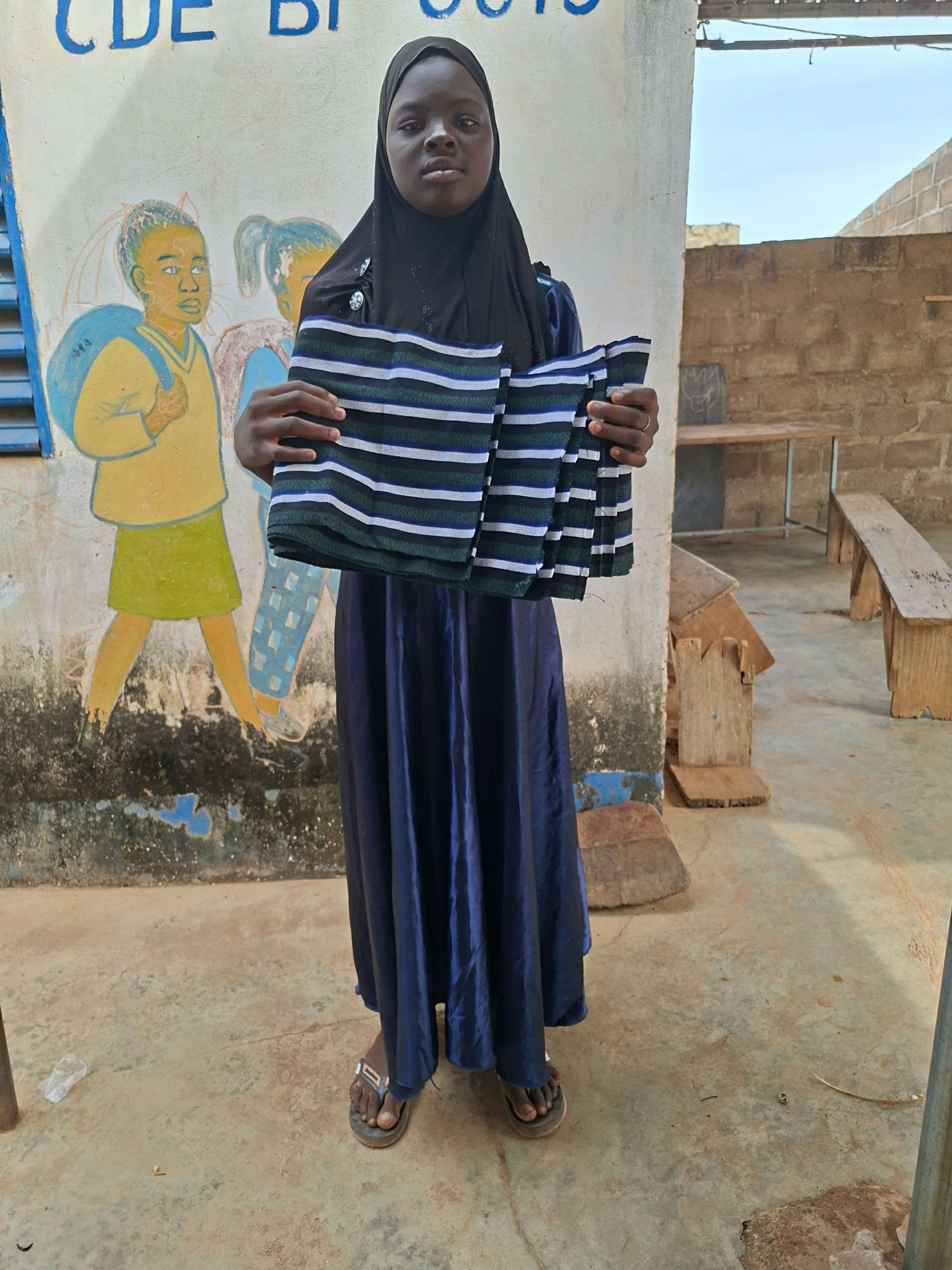 A young girl with the loincloth she wove