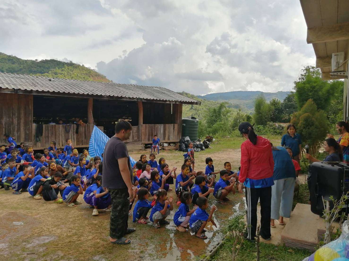 Children participating in outdoor camp activities in an open space, highlighting the need for a dedicated activity area to enhance their learning and play experiences.