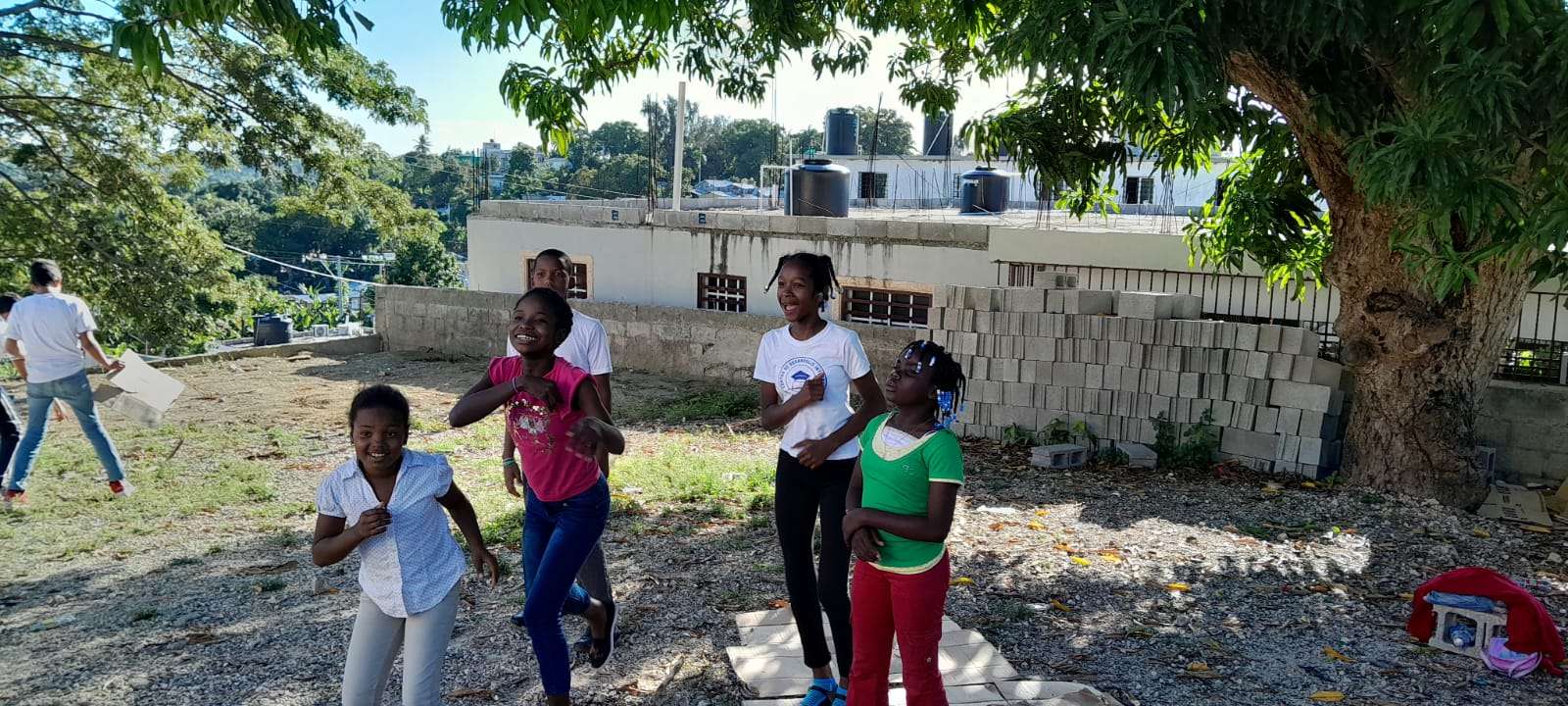 Children from the center playing in the dirt yard