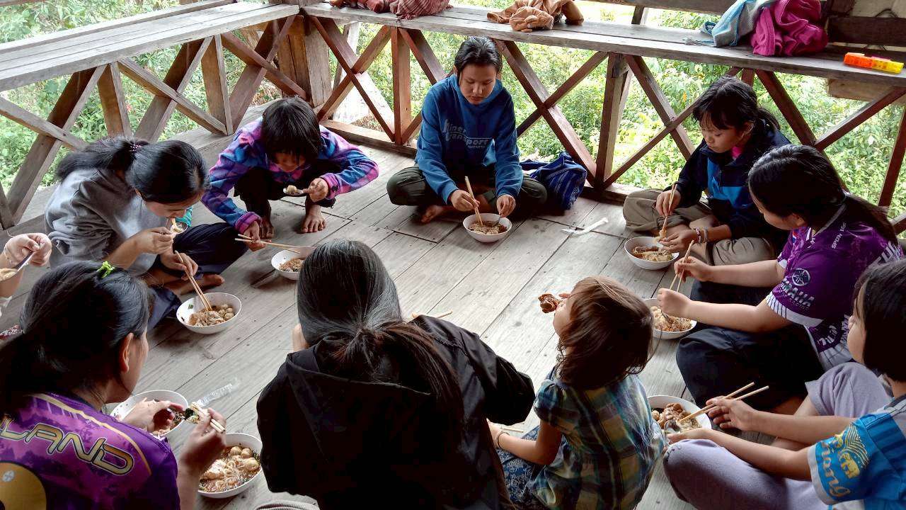 Children relaxing and enjoying their meals on the church balcony.