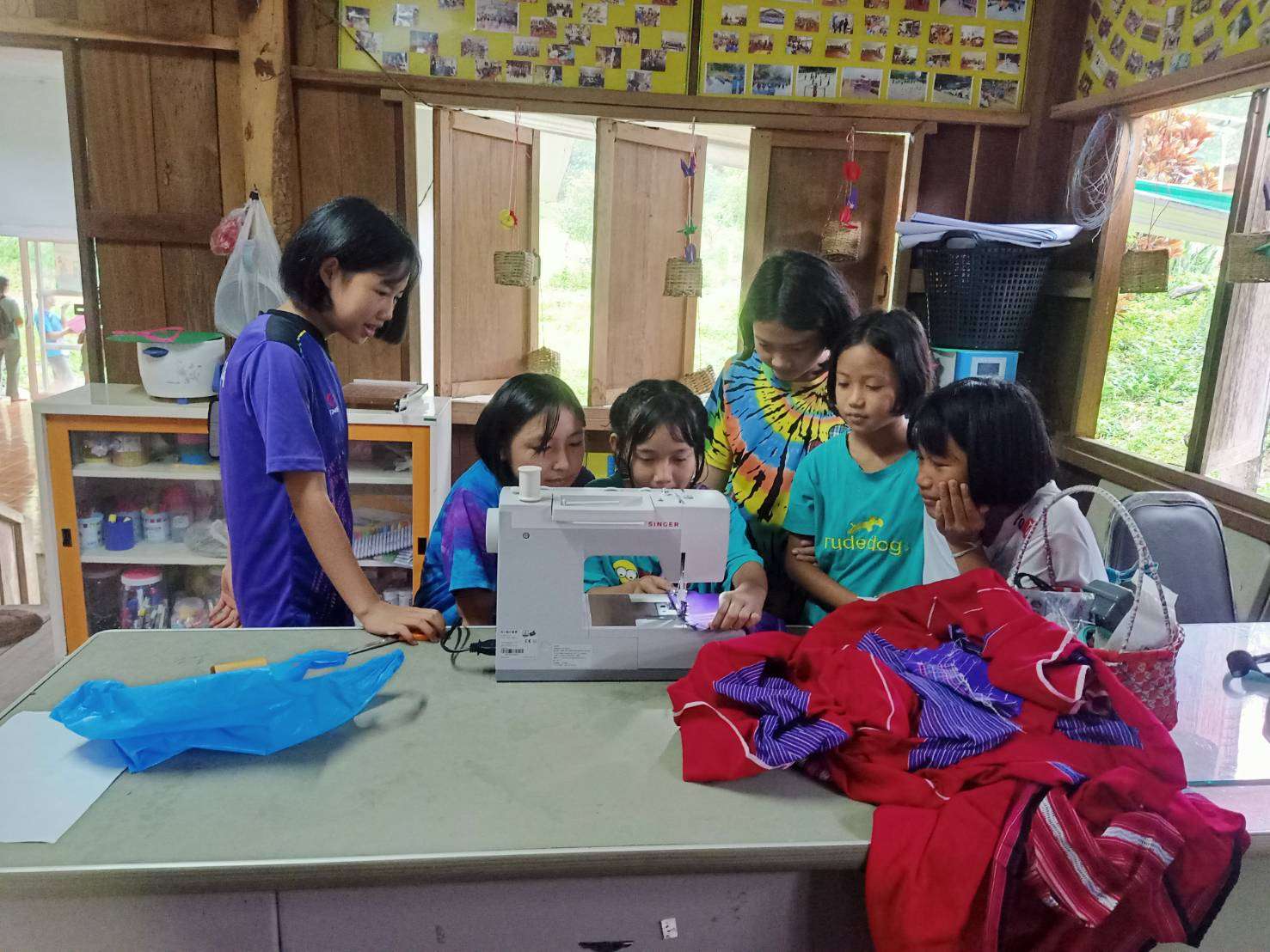 Children actively engaged in sewing activities.