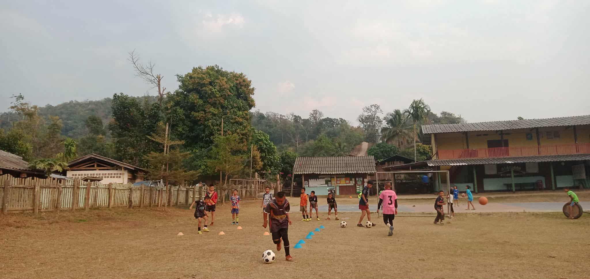 he children are putting in the effort to practice their football skills, working hard to improve and have fun!
