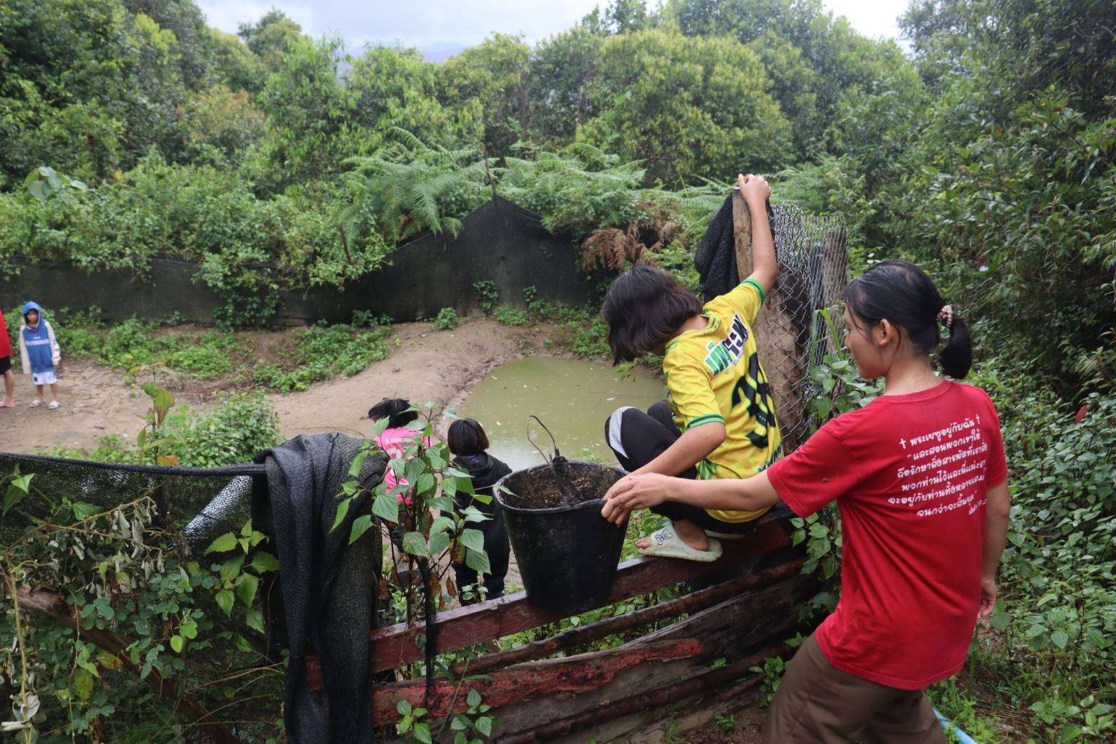 Picture of a child scooping water from the well