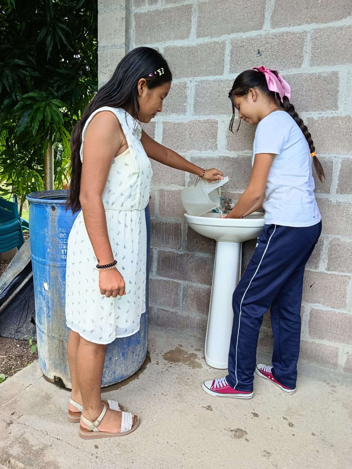 Young people using water to wash their hands