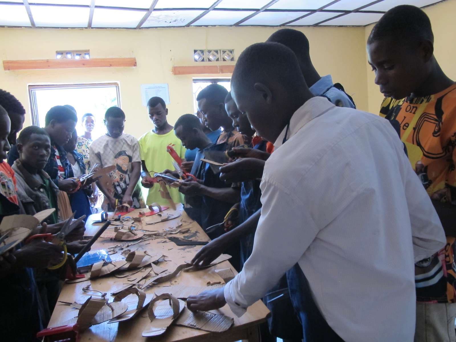 The participants showcase some of the shoes they have made from the skills obtained.     