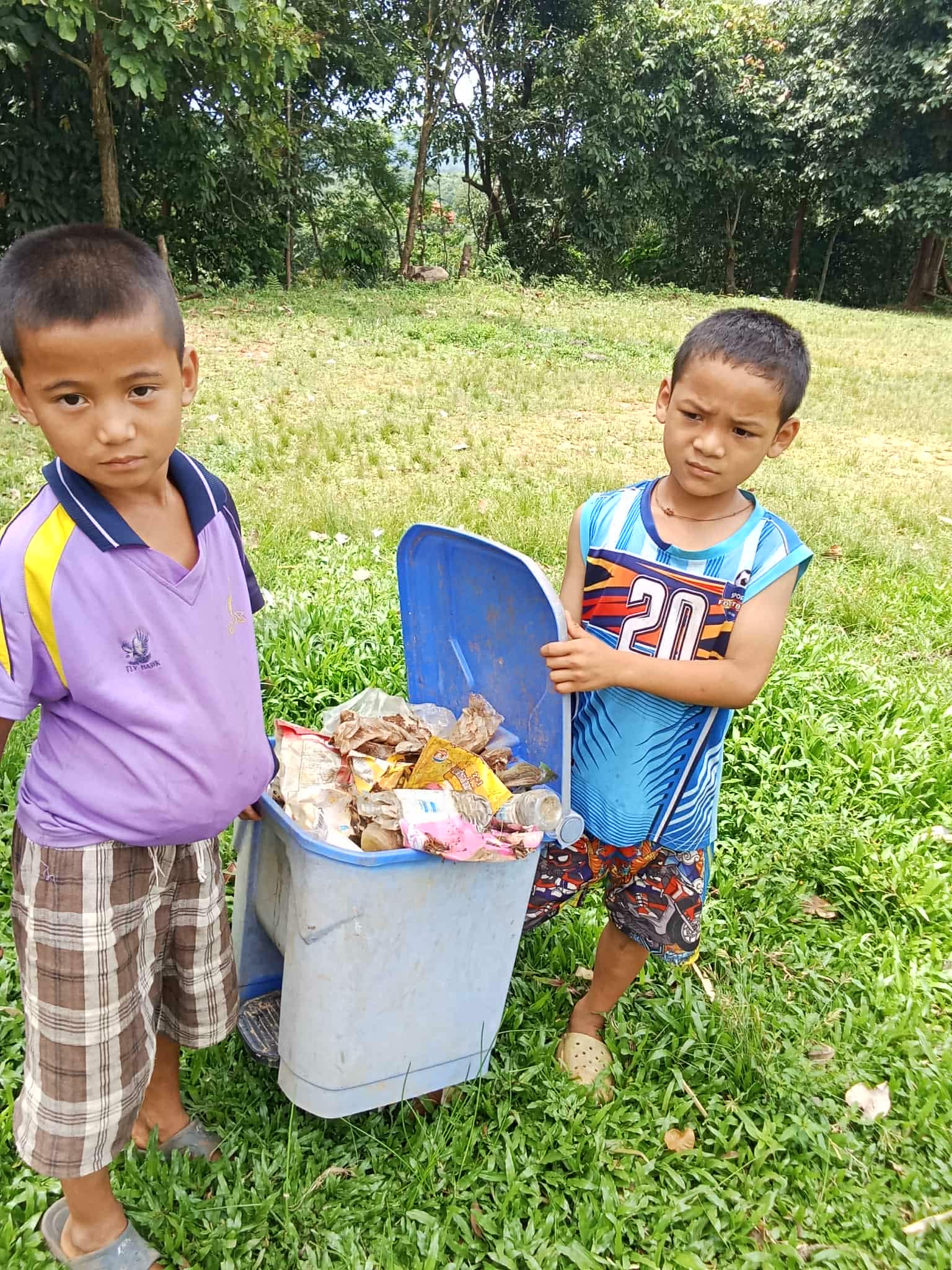 Children bring trash to throw away