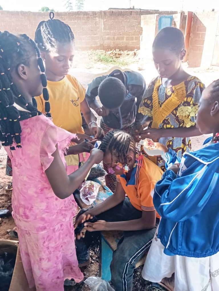 Participants at the center making braids